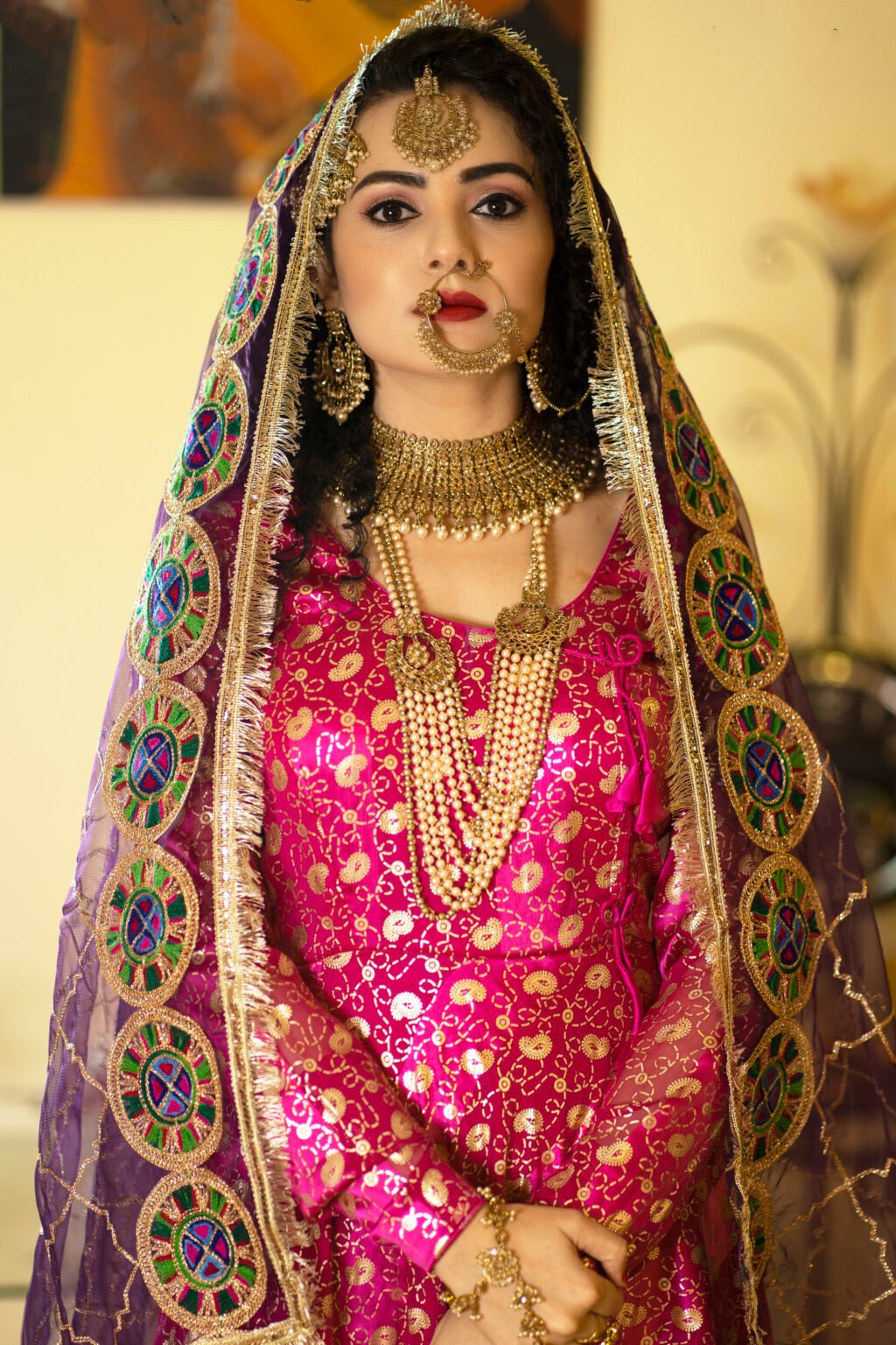 Bride in traditional gold jewellery and pink dress